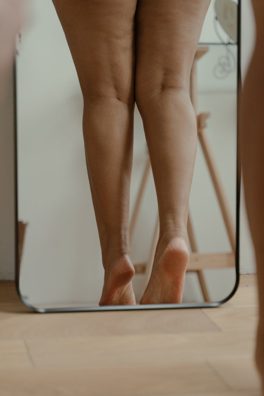 photo of a woman s legs on a mirror